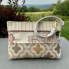 "Medium Size Wristlet. Neutral Color Wristlet with a Pearl Gray Leather Strap. Super Quality Industrial Upholstery Fabric. Large front zip pocket. Top zip opens to roomy interior. There's one inside pocket big enough for your credit cards,plus a large pocket that will fit a phone(or you could put it in the outside pocket ...)AND there's a clip off key ring 8.5\" wide 6\"deep 1 1/4\"bottom Use as your only bag, or use like a wallet and carry in a bigger bag. Great for an Evening bag , or when you Crossbody Wristlet With Zipper For Daily Use, Daily Use Crossbody Wristlet With Zipper Closure, Daily Crossbody Wristlet With Zipper Closure, Rectangular Beige Pouch With Zipper Closure, Everyday Handheld Coin Purse With Zipper, On-the-go Pouch Wristlet With Zipper Closure, Rectangular Wallets With Zipper Pouch For Everyday Use, Rectangular Wallets With Zipper Pouch, Everyday Handheld Wristlet With Zipper Pouch