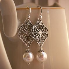 love these earrings Ornate Silver Jewelry With Pearl Drop, Ornate Silver Pearl Drop Jewelry, Intricate Silver Dangle Pearl Earrings, Silver Dangle Pearl Earrings With Intricate Design, Silver Intricate Dangle Pearl Earrings, Silver Pearl Drop Earrings With Intricate Design, Ornate Silver Pearl Earrings, Antique Silver Dangle Earrings For Wedding, Elegant Nickel-free Sterling Silver Bridal Earrings