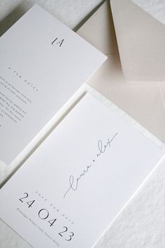 the wedding stationery is laid out on top of each other