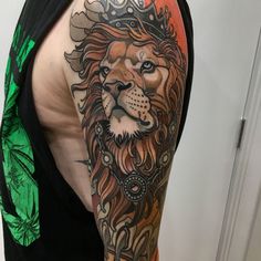 a man with a lion tattoo on his arm