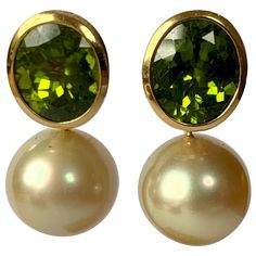 A pair of solid handcrafted 18 K yellow Gold earrings with 2 light golden South Sea pearls measuring 13.5 mm in Diameter. The top part features 2 bezel set fine Peridots totalling 11.47 ct. A truly very nice and wearable pair of earrings with a beautiful color combination. Masterfully handcrafted piece! Authenticity and money back is guaranteed. For any enquires, please contact the seller through the message center. South Sea Pearls Earrings, Golden Pearl, Golden South Sea Pearls, Citrine Jewelry, Precious Jewels, Sea Pearl, South Sea Pearls, Sea Pearls, Pearl Earrings Dangle