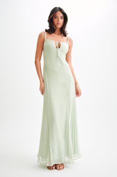 Fairytale summer.The SAIRA Chiffon Maxi Dress is a breathtakingly elegant piece designed to make a statement. This dress features a delicate ruffle neckline and a chic front keyhole, adding a touch of sophistication. The side panels at the hips with skirt pleating create a beautiful silhouette, while the flared hem adds a graceful flow. The maxi length ensures a stunning presence, and the adjustable straps provide a perfect fit. Fully lined for comfort, the Saira Chiffon Maxi Dress is perfect fo Pastel Ruffle Dress, Pastel Green Dress, Capsule Wardrobe Accessories, Dress Pastel, European Summer Outfits, Pastel Dress, Beautiful Silhouette, Green Pastel, Maxi Dress Sale