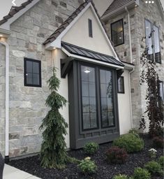 a house that has some plants in front of it