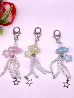 three charms with beads and stars on them