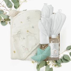 the baby's gift set includes an unwrapped blanket, bib and bottle