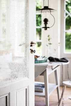 an open door leading to a dining room with a table and chairs in front of it