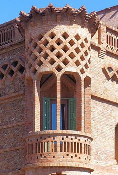 an ornate brick building with green shutters