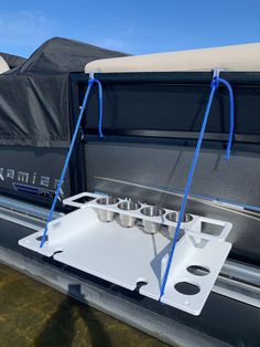 the back end of a boat with two cups attached to it's front rack