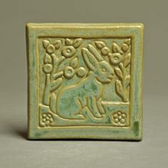 a ceramic tile with an animal on it