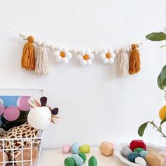 a giraffe stuffed animal sitting next to a basket filled with balloons and tassels