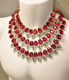 "Hello, welcome to Ken's Closet *My camera didn't like the red color* All red crystals are the same color. In the picture, they look like a mixture of red, pink, and orange. Today we have a beautiful 3 strand Ruby Red and Diamond Clear Crystal Necklace. The crystals are set in gold metal, they really bring out the color. Large crystals are accented by smaller Clear crystals. The necklace is appx 18\" long total. The hang is appx 5\" from the center top stand to the bottom 3rd strand. Crystals ar Red Crystal Necklace, Statement Jewelry Necklace, Wedding Jewelry Sets Bridal Jewellery, Clear Necklace, Blessed Wednesday, Clear Crystal Necklace, Neck Pieces Jewelry, Crystal Chandelier Earrings, Gem Necklace