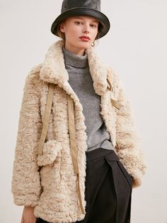 A fur jacket with a fluffy and voluminous silhouette that creates a romantic atmosphere. The front can be fastened with a band, and the high neck design protects your neck from the cold. 
 
 
 
 
 Size 
 
 
 S size 
 
 Length: 69cm 
 Shoulder width: 45cm 
 Bust: 116cm 
 Sleeve length: 55cm 
 
 M size 
 
 Length: 70cm 
 Shoulder width: 46cm 
 Bust: 120cm 
 Sleeve length: 56cm 
 
 
 
 
 
 Material 
 
 Polyester 
 
 
 Model worn 
 
 Wearing size 
 
 S size 
 
 Model dimensions 
 
 Height: 170cm 
 B Beige Faux Fur Coat For Fall, Cozy Fluffy Fur Coat For Fall, Fluffy Beige Fur Coat For Fall, Beige Faux Fur Coat For Winter, Beige Long Sleeve Fluffy Fur Coat, Cozy Beige Fur Coat For Cold Weather, Beige Faux Fur Coat For Cold Weather, Winter Beige Faux Fur Coat, Fluffy Beige Fur Coat For Winter