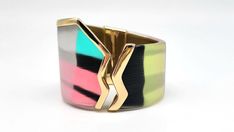 "Lucite Cuff Bracelet, Colorful Bangle Bracelet, Stained Glass Bracelet, Asymmetrical Bracelet, Graffiti Jewelry, Punk Cuff, Alexis Bittar Measurements: Fits up to 7.25\"L wrist. Width at widest point is 2\"W, at smallest point 1.5\"W Metal: Gold Tone Findings: Hinged Finish: Polished Excellent Condition You know that expression 'Party in the front, business in the back?' Yeah, this isn't that. This GORGEOUSLY UNIQUE piece from world famous jewelry designer Alexis Bittar is 100% PARTY ALL THE WAY AROUND! With a color scheme inspired by the wonderful 1980s this bright, colorful and happy piece will have you smiling all day long! Colors of Lucite include blue, pink, pale yellow, white and black, all of which have a STUNNING metallic sheen painted over the top. The front of the cuff features Modern Adjustable Multicolor Cuff Bracelet, Modern Multicolor Cuff Bangle Bracelet, Modern Multicolor Bangle Cuff Bracelet, Bold Party Bracelet Jewelry, Multicolor Bangle Cuff Bracelet For Party, Elegant Multicolor Metal Cuff Bracelet, Elegant Multicolor Cuff Jewelry, Modern Green Cuff Bangle Bracelet, Multicolor Fusion Style Bracelets For Party