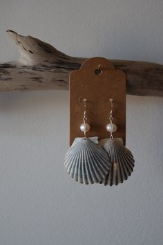 No two shells are alike and that's what makes these earrings so special. These scallop shells were found off the beaches of CT & RI. Paired with pearls, these scallop shells make the perfect set.  Made with silver coated brass & copper wire, plastic pearls & sterling silver earring wires. All shells are found, properly cleaned & up cycled.  Each purchase is packaged in a 100% recycled jewelry box, a 100% recycled padded mailer, 100% recycled tissue paper & hemp twine. Nickel-free Ocean-inspired Shell-shaped Shell, Ocean-inspired Nickel-free Shell-shaped Shell, Nickel-free Ocean-inspired Shell, Dangle Shell Earrings With Pearl Drop, Dangle Pearl Drop Shell Earrings, Pearl Drop Dangle Shell, Shell-shaped Shell Earrings With Ear Wire, Shell-shaped Earrings With Ear Wire, Handmade Shell-shaped Pearl Earrings For Gifts