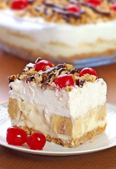 a piece of ice cream pie with cherries on the top is sitting on a plate