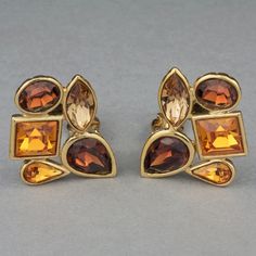 Features: - 100% Authentic YVES SAINT LAURENT. - Faceted and geometric citrine amber rhinestones. - Clipback earrings. - Gold tone hardware. - Signed YSL Made in France. - Excellent vintage condition. Measurements: Height: 1.34 inches (3.4 cm) Width: 1.02 inches (2.6 cm) Weight per Earring: 15 grams **These earrings will be shipped via Priority Shipping with tracking number. Please convo me for any queries and additional photos. Thank you for visiting. Other Fees that buyers need to know: Please Vintage Yves Saint Laurent, Jeweled Earrings, Rhinestone Earrings, Earrings Photo, Earrings Gold, Made In France, Citrine, Clip On Earrings, Tracking Number