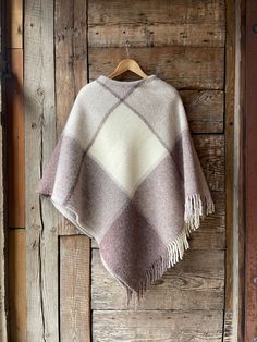 Beige wool blanket poncho cape with fringes Beige poncho large check lambswool poncho cape Pure lambswool poncho large check ladies poncho One size fits fashionably for most everyone, short or tall, big or small. This piece is versatile for both Men's & Women's outdoor fashion, and can be used insider in cooler winter weather to keep warm while reading on the couch. CARE: Hand-wash and hang to dry, light iron if needed, or dry clean. MEASURES: Length at the front of the neckline to the bottom is Womens Outdoor Fashion, Winter Poncho, Blanket Poncho, Ladies Poncho, Outdoor Fashion, Poncho Cape, Winter Weather, Wool Blanket, Shoulder Length