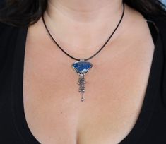 This necklace features a stone called shattuckite, which is from Arizona. It has gorgeous blue color with some pretty veining of black which is outlined in a lighter blue color. Really beautiful stone and the extra bit of dangle make it a really fun flirty piece. Pendant is just 1 1/4 inches long and with the chain tassel 2 3/4 inches ♦Chain: This comes either on a very nicely weighted silver cable chain or leather cord and you can choose your preference when you add to cart. The silver chain ha Blue Chrysocolla Necklace With Stones, Blue Chrysocolla Necklace With Large Stone, Blue Chrysocolla Pendant Necklace, Artisan Blue Necklace With Large Stone, Blue Chrysocolla Pendant Jewelry, Blue Sodalite Pendant Necklace, Blue Chrysocolla Jewelry With Large Stone, Blue Agate Cabochon Jewelry, Iolite Necklace