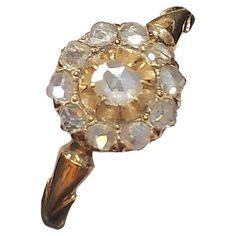 Antique imperial russian era ring in a floral designe ring head designe centered with a small rose cut diamond flanked with smaller rose cut diamonds in 14k yellow gold ring head diameter 9mm hall marked 56 imperial russian gold standard