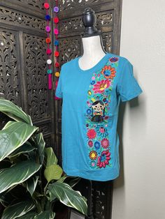 This is a light weight and fresh looking beautiful soft and solid embroidered blouse. It will look great with jeans. The embroidered work is beautiful and delicate. The design has a precious thread embroidered floral pattern. All the work is clean, and with a professional look. You will Love it! Blouse STYLE DETAILS Overview * embroidered flowers * short sleeves fabric & care * hand wash only * delicate care * hang dry If you have any questions, please message me before buying. See you soon. Crew Neck Blouse With Floral Embroidery, Embroidered Crew Neck Blouse, Cotton Crew Neck Top With Embroidered Hem, Spring Cotton Embroidered Top With Machine Embroidery, Multicolor Floral Embroidery T-shirt For Summer, Embroidered Cotton Crew Neck Blouse, Embroidered Crew Neck Cotton Blouse, Embroidered Blouse With Relaxed Fit And Crew Neck, Bohemian Cotton Tops With Machine Embroidery