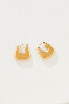 Like our favourite micro bag, the Raegen Earrings are all modular in shape offering massive style on a small scale. An angular gold hoop that cuts away at the lobe, she takes a look from cas to professional, from lacking personality to doling it out in bucketloads. She's ready to break hearts (your own included). Features a hinge clasp. Micro Bag, Arrow Earrings, Frankies Bikinis, Loafer Mules, Scarf Gift, Kids Swimming, Shoe Size Chart, Gold Hoop, We Wear