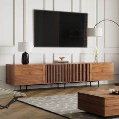 a living room with a large flat screen tv mounted on the wall and wooden furniture