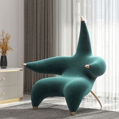 a green star shaped chair sitting on top of a rug