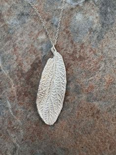 Unique handmade silver pendant from a Viburnam leaf, from East Sussex, England. Comes with an 18 inch sterling silver chain and a box. Please note the pendant is unhallmarked, fine silver. Silver Leaf-shaped Necklace Gift, Handmade Silver Leaf-shaped Necklace, Silver Leaf-shaped Necklaces For Gift, Silver Leaf-shaped Necklace For Gift, Handmade Sterling Silver Leaf-shaped Necklace, Handmade Sterling Silver Leaf Necklace, Silver Leaf-shaped Sterling Silver Necklace, Silver Leaf-shaped Nature-inspired Necklace, Sterling Silver Leaf Necklace