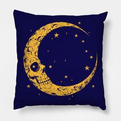 a yellow and blue pillow with a skull sitting on the moon in front of it