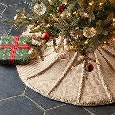 a christmas tree skirt with presents under it