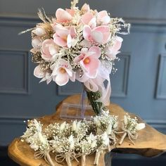 a bouquet of flowers sitting on top of a wooden table