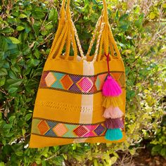 This unique bag is beautifully made on a waist loom, (Telar de Cintura) by artisans from Chiapas México.Each bag is individually handwoven with a unique colors and designs . There is not other like it! Use this reusable and eco-friendly, 100% cotton loom tote bag as a shopping bag for farmer's markets . Dress it down with a t-shirt and jeans or shorts! or to add a boho vibe to any outfit. Details: Tote measurements: 14 x 16.5 inch Handle drop: 10" Material: 100% Cotton Main color : Mustard All i Multicolor Handwoven Crochet Tote Bag, Artisan Handwoven Bags For Festival, Artisan Handwoven Festival Bags, Yellow Bohemian Festival Bags, Handwoven Tote Bag For Festival, Handmade Multicolor Beach Bag For Festivals, Artisan Multicolor Handwoven Bag, Artisan Multicolor Handmade Beach Bag, Multicolor Handwoven Artisan Bag