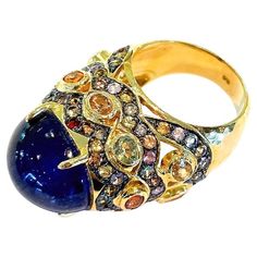 Bochic "Capri” Blue & Multi color Sapphires Ring Set in 18K Gold & Silver Natural Blue Sapphire Cabochon - 12 Carats Natural Multi color Sapphires, round and oval brilliant shapes - 7 carats This Ring is from the "Capri" traveling collection and it is the epitome of elegance and versatility. The ring offers a perfect blend for day to night and swimwear to evening wear, allowing you to effortlessly transition between different occasions and outfits. Wearing this cocktail style ring will undoubtedly make you the center of attention. The ring adds a touch of glamour and sophistication to your favorite caftans, swimwear, or evening attire, enhancing your overall look. The "Capri" collection, from which this ring originates, showcases exceptional craftsmanship and incorporates natural gemstones Luxury Multi-stone Cabochons Fine Jewelry, Luxury Multicolor Cabochon Jewelry, Sapphire Cabochon, Capri Blue, Natural Blue Sapphire, Evening Attire, Cocktail Rings, Gold And Silver, Evening Wear