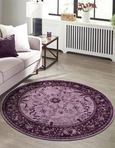 a living room filled with furniture and a purple rug