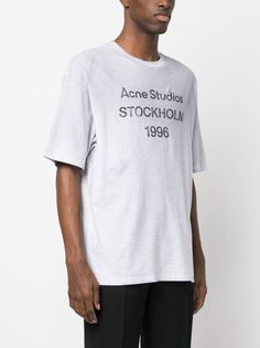 Find ACNE STUDIOS Logo Stockholm 1996-print T-shirt on Editorialist. light grey black cotton jersey knit mélange effect logo print to the front round neck short sleeves straight hem This item is made from at least 50% organic materials. Learn more about what makes a product Conscious on our Conscious Criteria page Heather Grey Graphic Tee With Logo Print, Gray Crew Neck T-shirt With Logo Print, Gray Cotton T-shirt With Logo Print, Acne Shop, Studio Logo, Organic Materials, Logo Print, Stockholm, Black Cotton