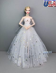 a barbie doll wearing a white dress with stars on it