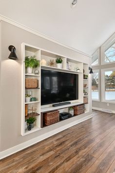 a large flat screen tv mounted to the side of a wall in a living room