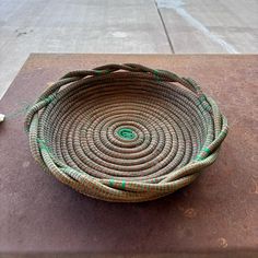 a woven basket sitting on top of a sidewalk