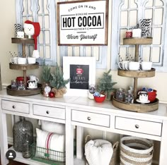 a white table topped with lots of shelves filled with christmas decorations and decorating items