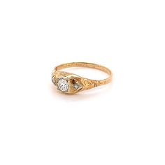 a gold ring with two diamonds on it