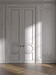 an empty room with two white doors and wood flooring is shown in this image