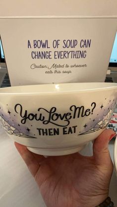 someone is holding a bowl that says you love me then eat