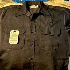 Great Timeless Retro Find. Beautiful Black Uniform Shirt From Flying Cross. Flying Cross Has Been Supplying Apparel To Several Branches Of The Armed Services Since The 1800s. Prized For Their Durability, Comfort, And Quality Of Design And Construction, They Are The Go-To Shirts For Public Safety Professionals Such As Police, Fire, Emts, Security Guards, Postal Workers, Airline Employees, Etc. You Will Look Neat And Professional While Being Stylish And Comfortable In This Never-Worn Shirt. Beauti Fitted Short Sleeve Black Shirt With Buttons, Vintage Black Buttoned Tops, Vintage Black Tops With Buttons, Vintage Black Shirt With Button Closure, Fitted Black Button-up Short Sleeve Shirt, Fitted Black Short Sleeve Button-up Shirt, Fitted Black Tops With Pockets, Black Vintage Short Sleeve Shirt, Fitted Black Shirt With Pockets