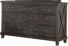 the dresser is made from dark wood and has metal handles on one side, and an x design on the other