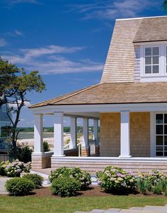 a small house with white trim and windows