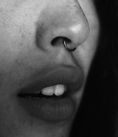 a close up of a person with a nose ring