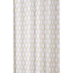 a white shower curtain with gold circles on it