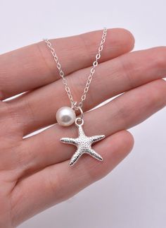 This lovely necklace is perfect for a beach or summer wedding. The sterling silver necklace is available in your choice of length and features an 8mm high quality crystal pearl (5 colors available) and a silver plated starfish charm. Secures with a sterling silver spring clasp. Comes in a gift box, perfect for gift-giving! Contact me for quantity discount pricing. **IMPORTANT: Please measure carefully and then select your necklace length at checkout. Note that necklaces will fit differently depe Necklaces Beach, Bridesmaid Pearl Necklace, Bridesmaid Necklaces, Floating Pearl Necklace, Beach Wedding Jewelry, Bridesmaid Pearls, Silver Pearl Necklace, Starfish Necklace, Bridesmaid Proposal Gifts