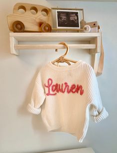 Knit infant sweaters with customized names for your little one! Perfect for a baby shower gift, gender reveal, name reveal, birthday present etc I will create 4 digital proofs of what the sweater will look like (4 different font choices) and will only begin production once you approve the design.  If there are any sweater or yarn colors (or larger sweater size) you would like but don't see available, just send me a message and we can make that happen :) (the turn around time might be a couple we Gender Reveal Just For Couple, Personalized Pink Long Sleeve Sweater, Personalized Pink Crew Neck Sweater, Personalized Pink Sweater For Winter, Personalized White Cotton Sweater, Personalized White Sweater For Winter, Customizable Cute Crew Neck Sweater, Cute Customizable Crew Neck Sweater, Cute White Sweater With Custom Embroidery