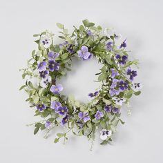 a wreath with purple flowers and green leaves